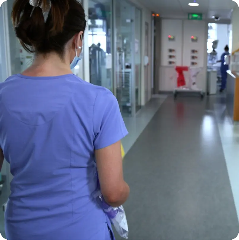 Video thumbnail of a nurse walking through a hospital corridor