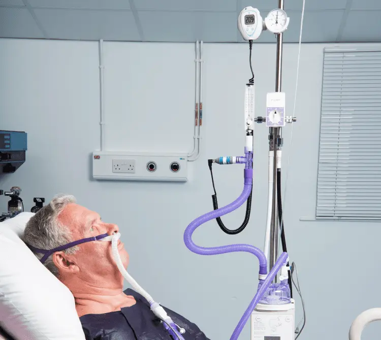 A patient connected to an Armstrong Medical High Flow system called POINT. It is a high flow oxygen therapy system designed for use in peri-operative humidification care.